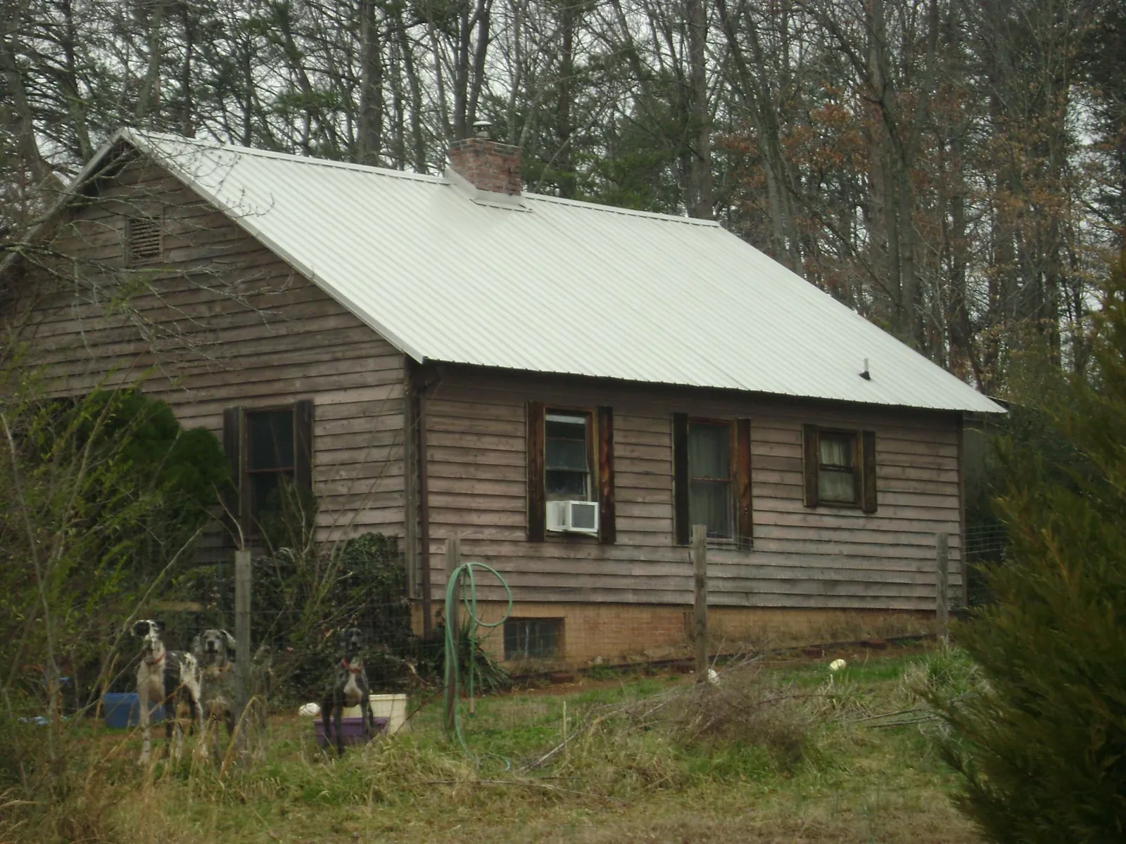 White metal roof on an old wood sided farmhouse, from a Metal Roof Installation job in Livermore